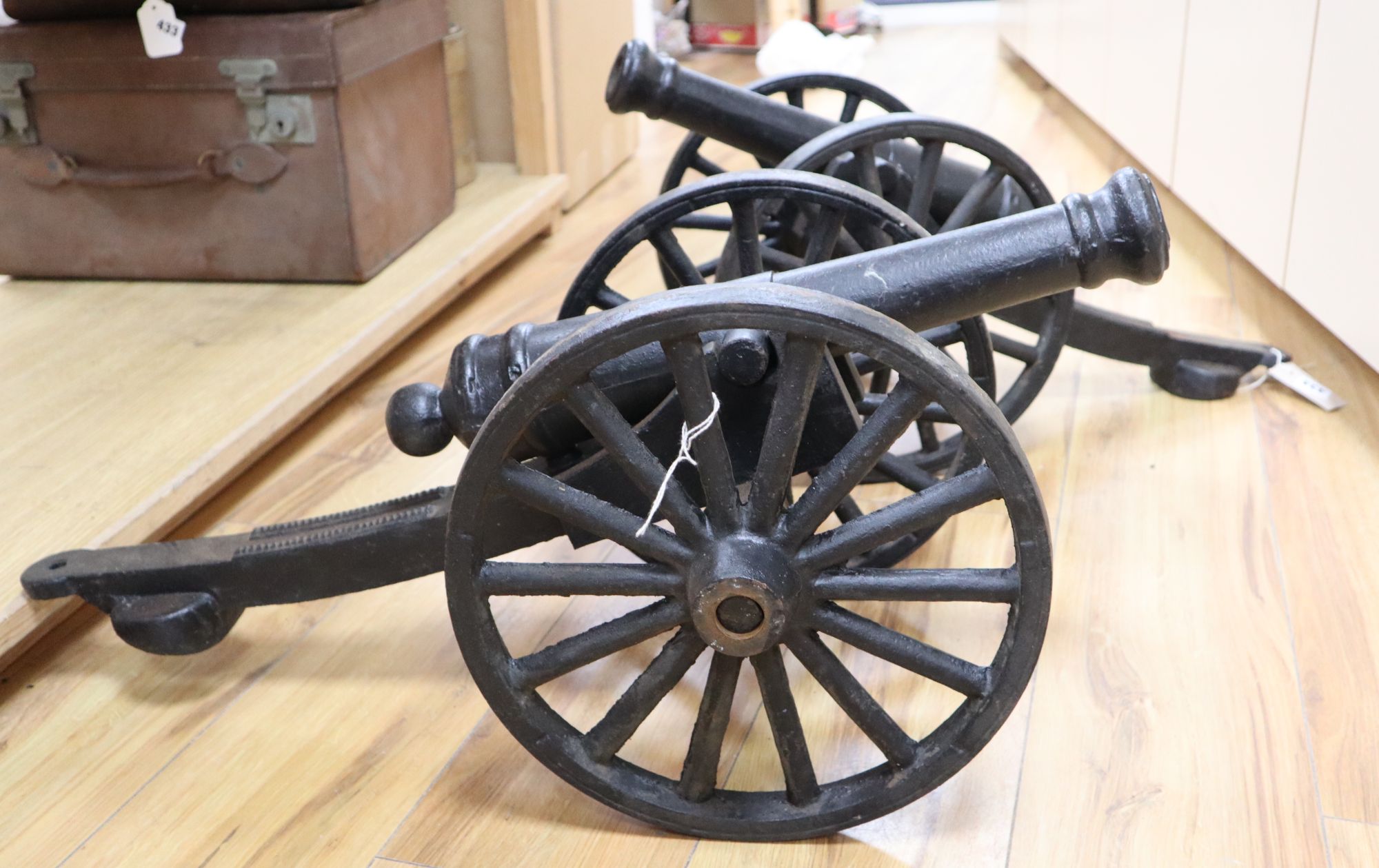 A pair of cast iron models of cannons, length 71cm